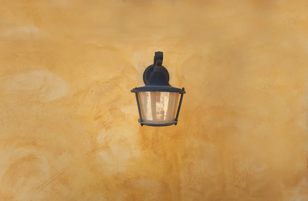 old lamp on yellow wall