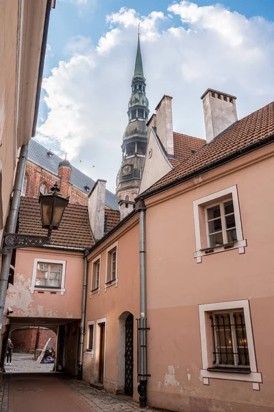 Arka planda Aziz Peter Kilisesi olan Riga Eski Kasabasının dar sokakları