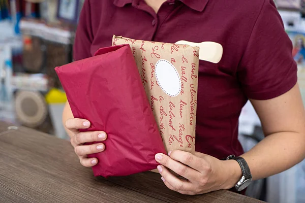 Delivery mail post postal packages red and craft paper box in hands