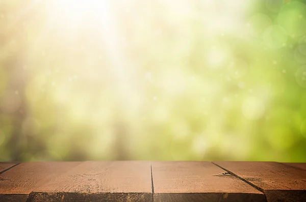 empty wooden table in the foreground. abstract defocus forest in the background