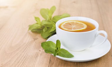 Tahta bir masada limonlu ve naneli çay.