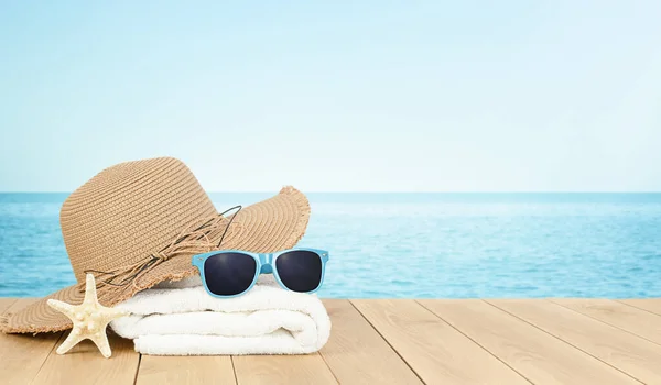 towel, sun hat, sunglasses and starfish on defocus sea background