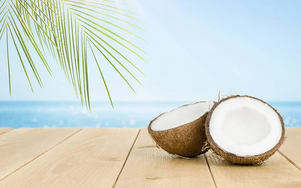 Kokosnoot Een Houten Tafel Tegen Achtergrond Van Een Onscherpe Zee — Stockfoto