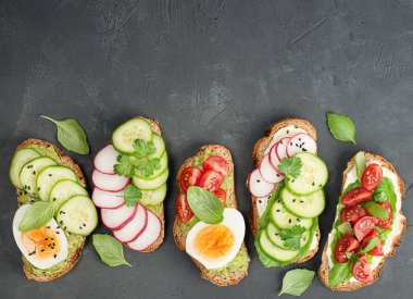 Siyah bir masada beş farklı ekmek kızartması.