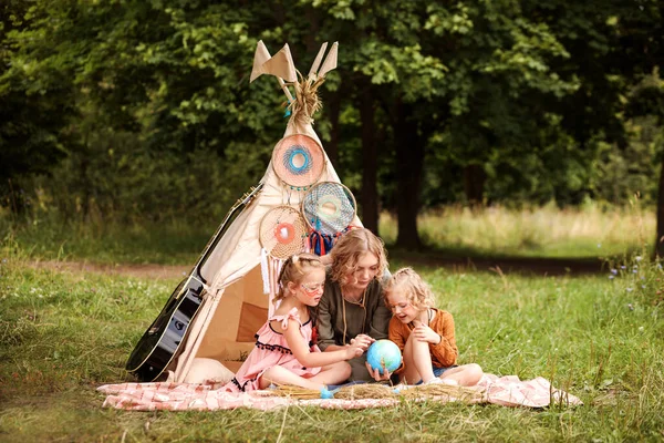 Mom is studying her daughters geography in a playful way. Summertime, outdoors