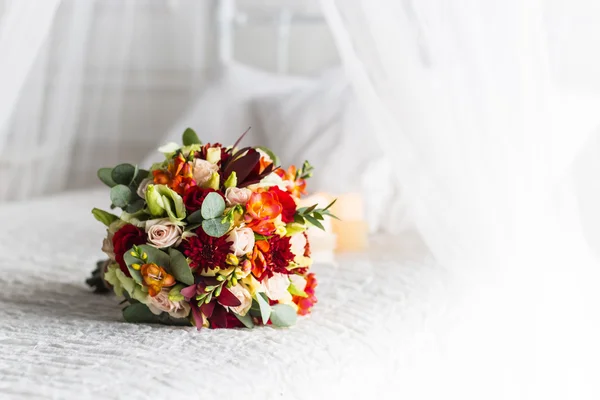 Beautiful bouquet of colorful flowers and green roses lying on a chair close-up — Stock Photo, Image