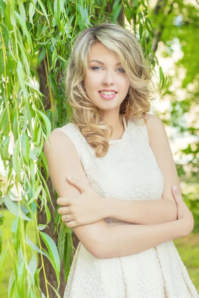 Ritratto di una bella ragazza sexy con grandi labbra gonfie con capelli bianchi in un vestito bianco vicino a un albero — Foto Stock