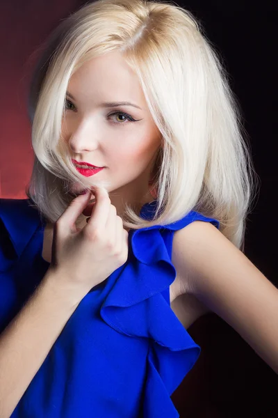 Elegante schöne Blondine mit roten Lippen in einem blauen Kleid im Studio — Stockfoto