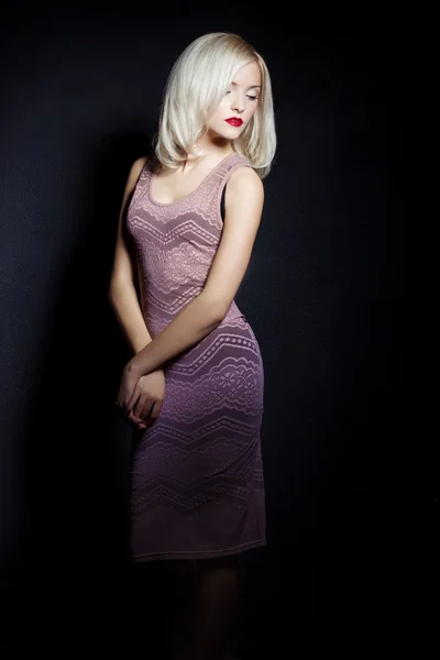 Portrait of a beautiful sexy women blonde with red lipstick and arrow keys on the eyes in a pink dress in the Studio — Stock Photo, Image