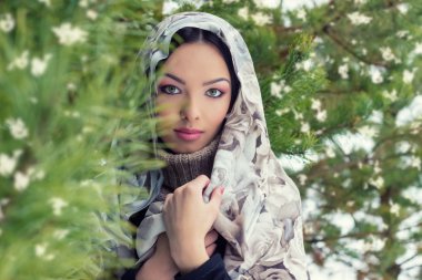 Bir eşarp kış orman düşen kar köknar ağaçları, yakınındaki kafasındaki çekici genç kadın