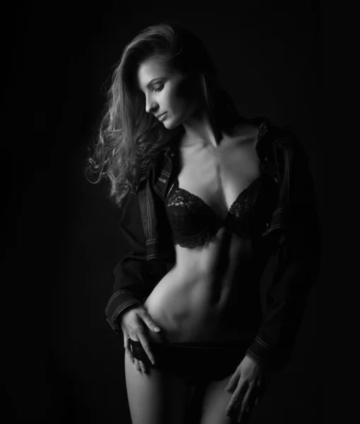 Black and white silhouette of a young, sporty and sexy woman in the lower black lingerie — Stock Photo, Image