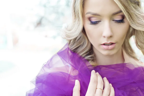 Portrait of beautiful sexy cute girls blonde with beautiful gentle makeups flower garden with purple tulle on the shoulders — Stock Photo, Image