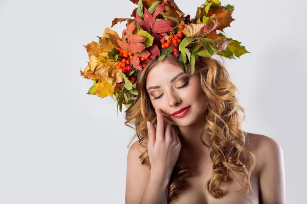 Estilo retrato moda hermosa chica sexy con caída de pelo rojo con una corona de hojas de colores y ceniza de montaña color brillante maquillaje de moda en tonos naranjas —  Fotos de Stock