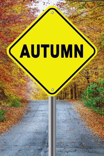 Autumn cautionary road sign against a fall background — Stock Photo, Image