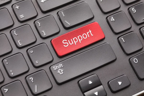 Red Support key on black keyboard Stock Picture