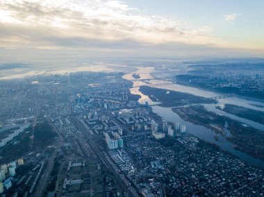Kiev üzerinde havadan yüksek uçuş, şehrin üzerinde sis bulutu. Sonbahar sabahı, Dinyeper Nehri ufukta görünüyor..