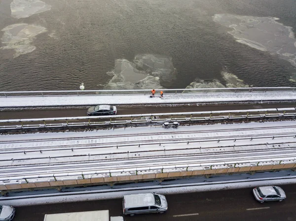 Snow-covered metro bridge in Kiev. Cloudy winter morning. Aerial drone view.