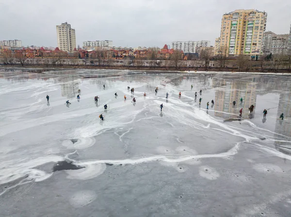 Fishermen on thin ice. Frosty drawing on ice. Aerial drone view. Winter cloudy morning.