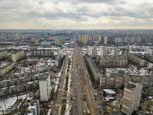 Kyiv road junction in light snow. Aerial drone view. Winter cloudy morning.