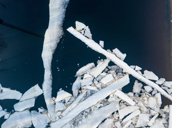 Ice melts on the river. Ice crack. Aerial drone view. Spring sunny morning.