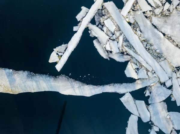 Ice melts on the river. Ice crack. Aerial drone view. Spring sunny morning.