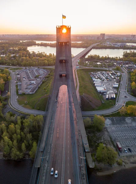 The rising sun through the pylon of the North Bridge in Kiev. Aerial drone view.