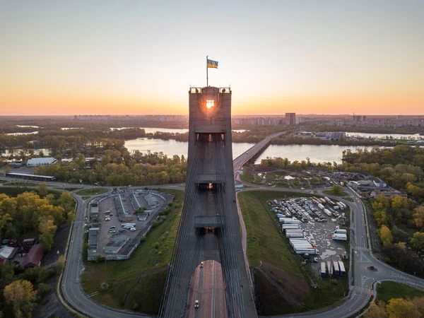 The rising sun through the pylon of the North Bridge in Kiev. Aerial drone view.