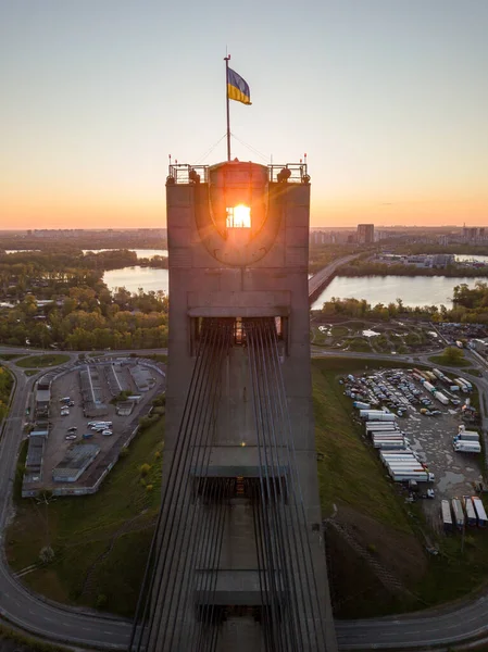 The rising sun through the pylon of the North Bridge in Kiev. Aerial drone view.