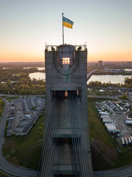 The rising sun through the pylon of the North Bridge in Kiev. Aerial drone view.