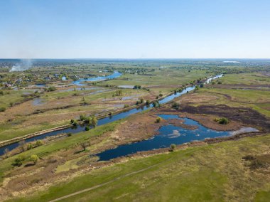 Yeşil bir çayırda nehir sızıntısı. Hava aracı görünümü.
