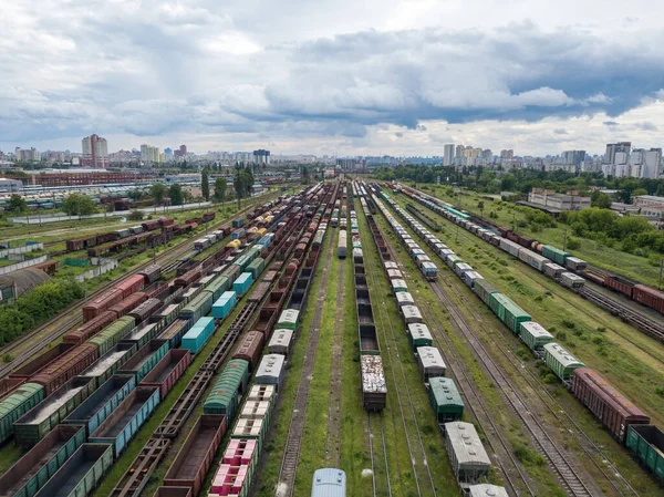 Freight trains on railway tracks. Aerial drone view. Sunny spring day.