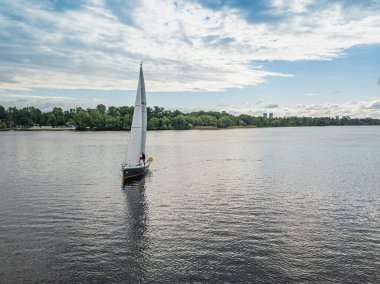 Yelkenli yat nehirde yüzüyor. Hava aracı görünümü.
