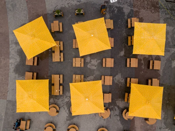 Square umbrellas in a cafe. Aerial drone view.