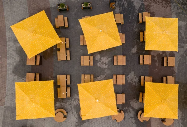 Square umbrellas in a cafe. Aerial drone view.