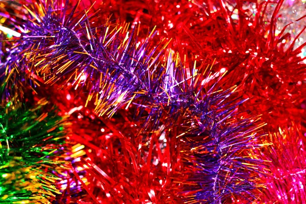 Festive multi-colored background with Christmas tinsel — Stok Foto