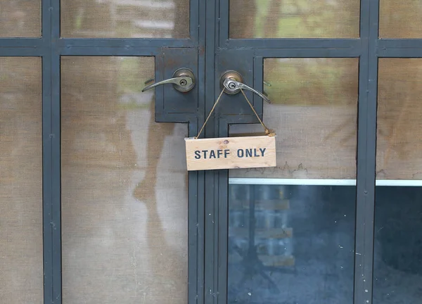 Staff Only Sign Hanging Handle Steel Door Stock Photo
