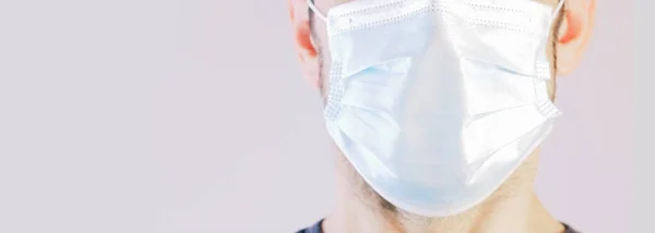 Close-up of a man\'s face with protective mask. Concept of protection against coronavirus