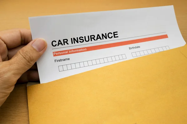 Formulaire de demande d'assurance auto sur enveloppe marron — Photo