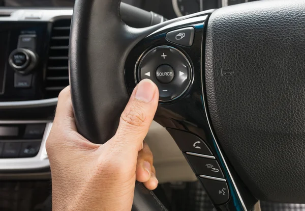 Hand pushes the cruise control button on a steering — Stock Photo, Image