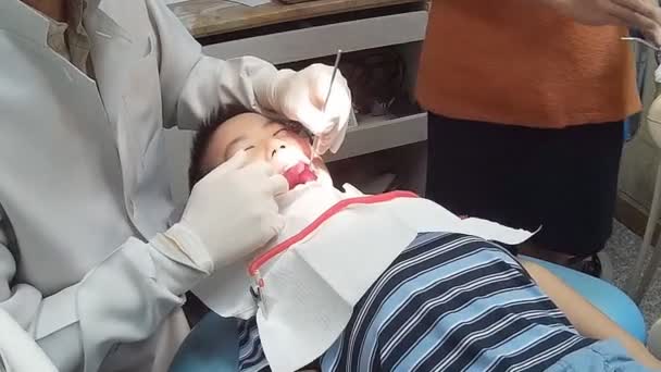 Lille pojken öppna munnen brett under inspektion av munhålan — Stockvideo