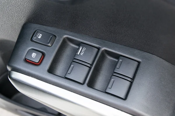 Car interior details of door handle with windows controls and ad — Stock Photo, Image