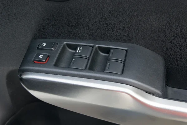 Car interior details of door handle with windows controls and ad — Stock Photo, Image