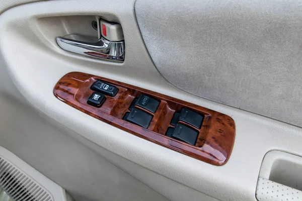 car interior details of door handle with windows controls and ad