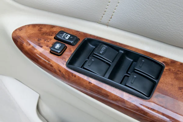 Car interior details of door handle with windows controls and ad — Stock Photo, Image