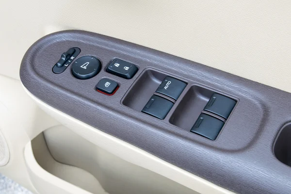 Car interior details of door handle with windows controls and ad — Stock Photo, Image