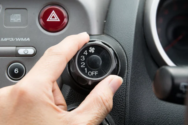 Man turning car air conditioner switch — Stock Photo, Image