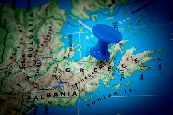 Map of Greece with a blue pushpin stuck