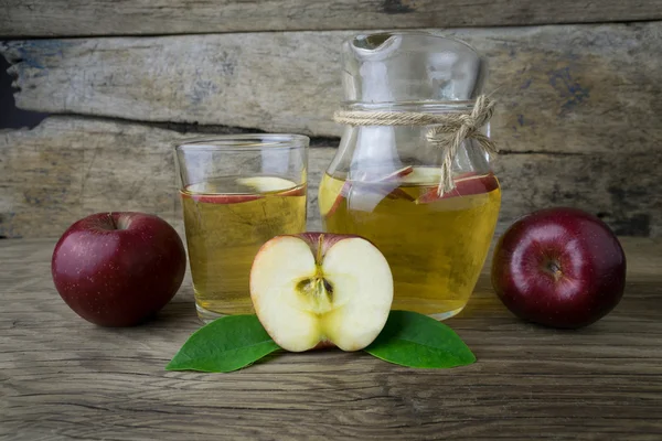 Apple juice and apples on a wooden table Stock Picture