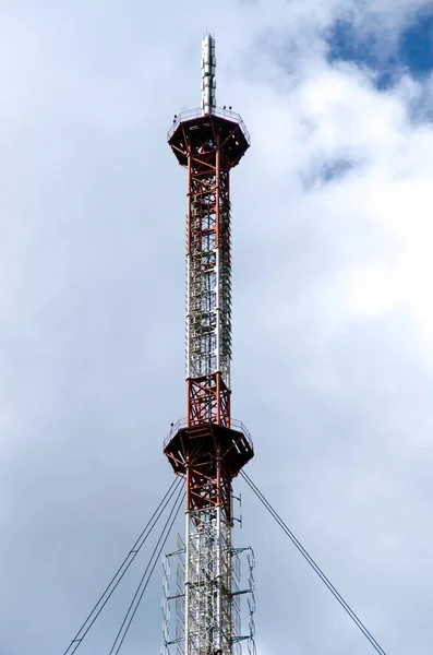 The plot of the tower close-up. TV tower against a cloudy blue sky.