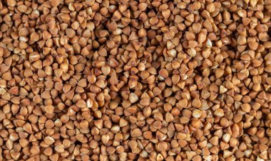 Organic uncooked buckwheat grain pattern background